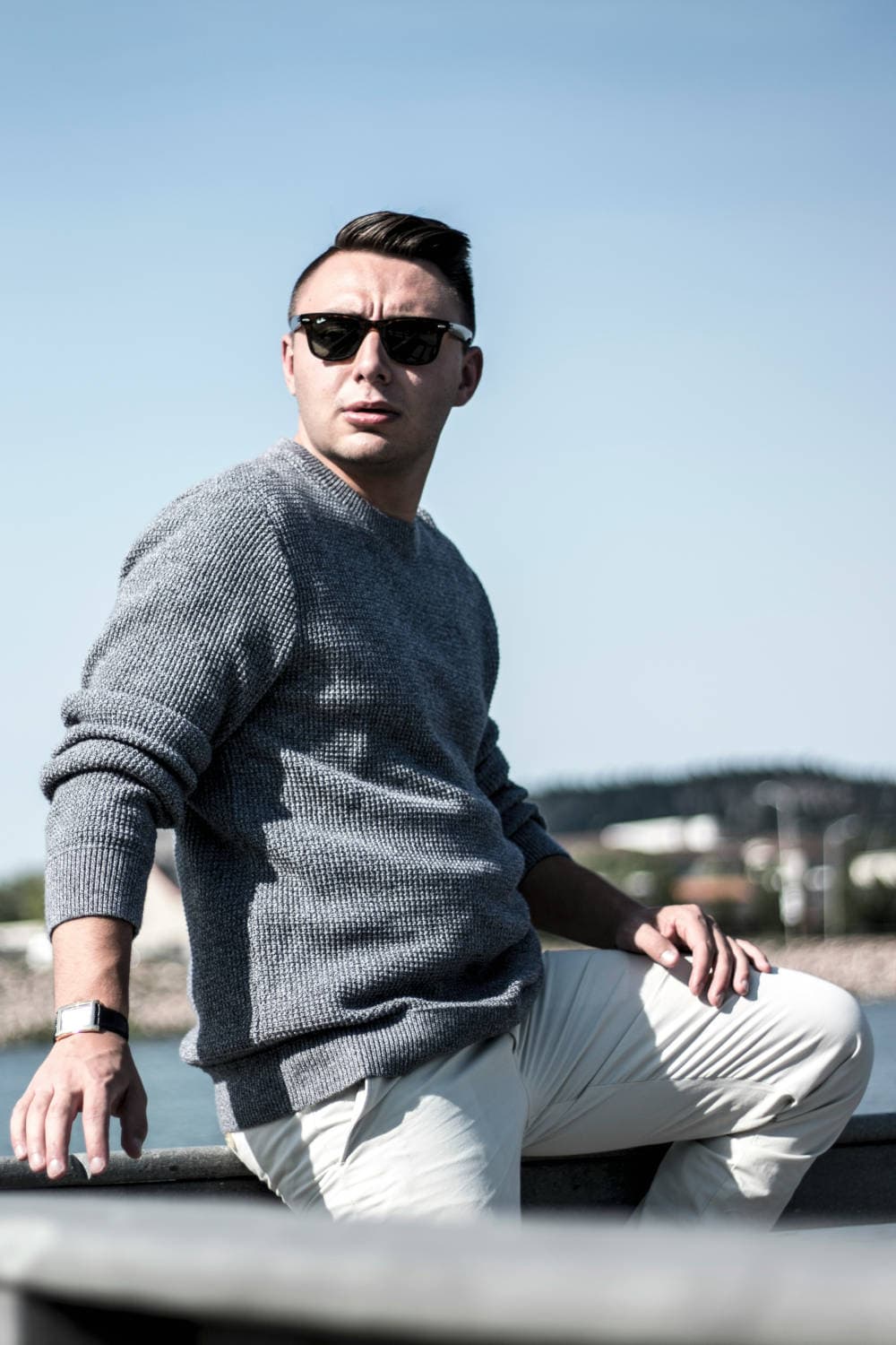 Neutral crewneck sweater layered into a minimalist men's wardrobe outfit