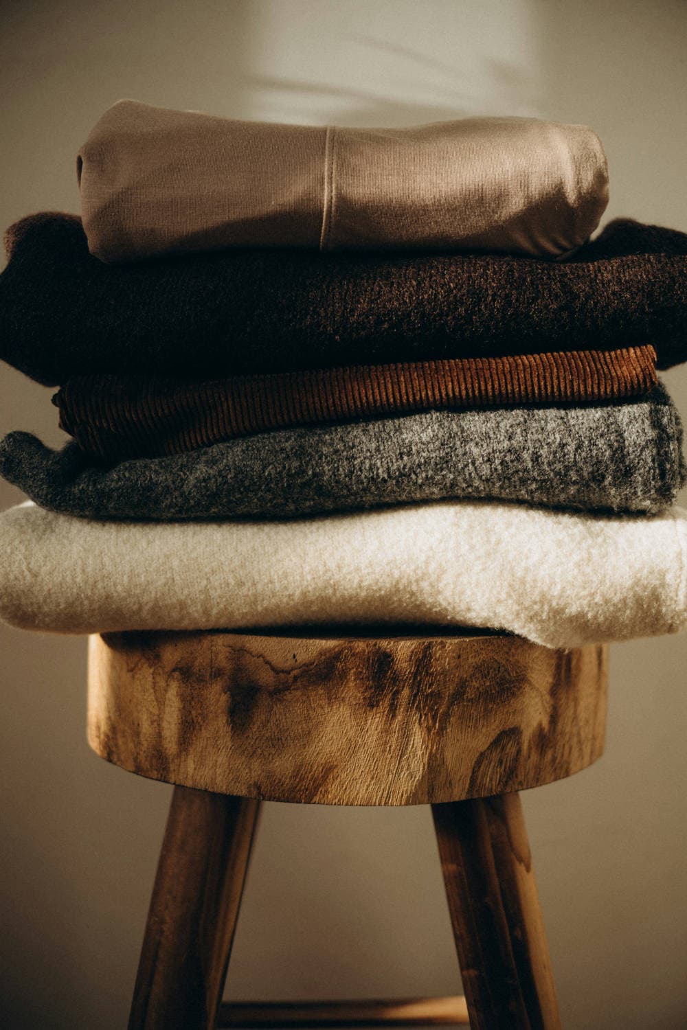 Neatly folded neutral-toned clothes