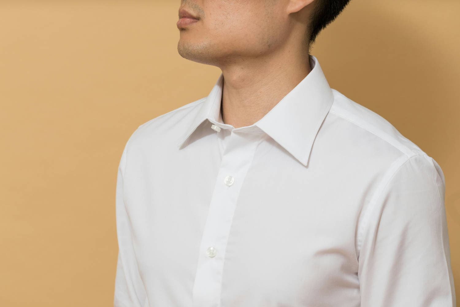 Crisp white shirt styled as a core men's wardrobe essential